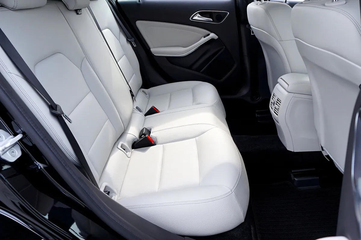 Clean light leather rear seats through an open door